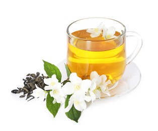 Photo of Aromatic jasmine tea in glass cup, flowers and dried leaves isolated on white