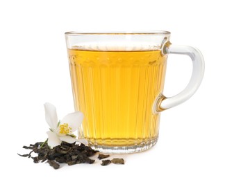 Photo of Aromatic jasmine tea in glass cup, flower and dried leaves isolated on white
