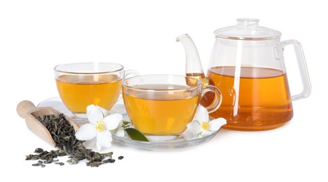 Photo of Aromatic jasmine tea in glass cups, teapot, flowers and dried leaves isolated on white