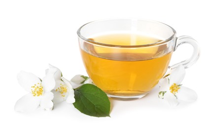 Photo of Aromatic jasmine tea in glass cup, flowers and green leaf isolated on white