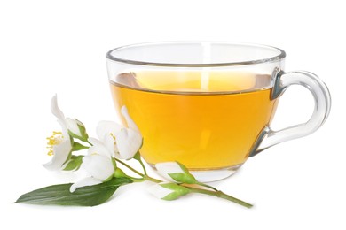 Photo of Aromatic jasmine tea in glass cup and flowers isolated on white