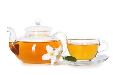 Photo of Aromatic jasmine tea in glass cup, teapot, flowers and green leaf isolated on white