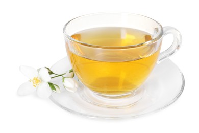 Photo of Aromatic jasmine tea in glass cup and flowers isolated on white