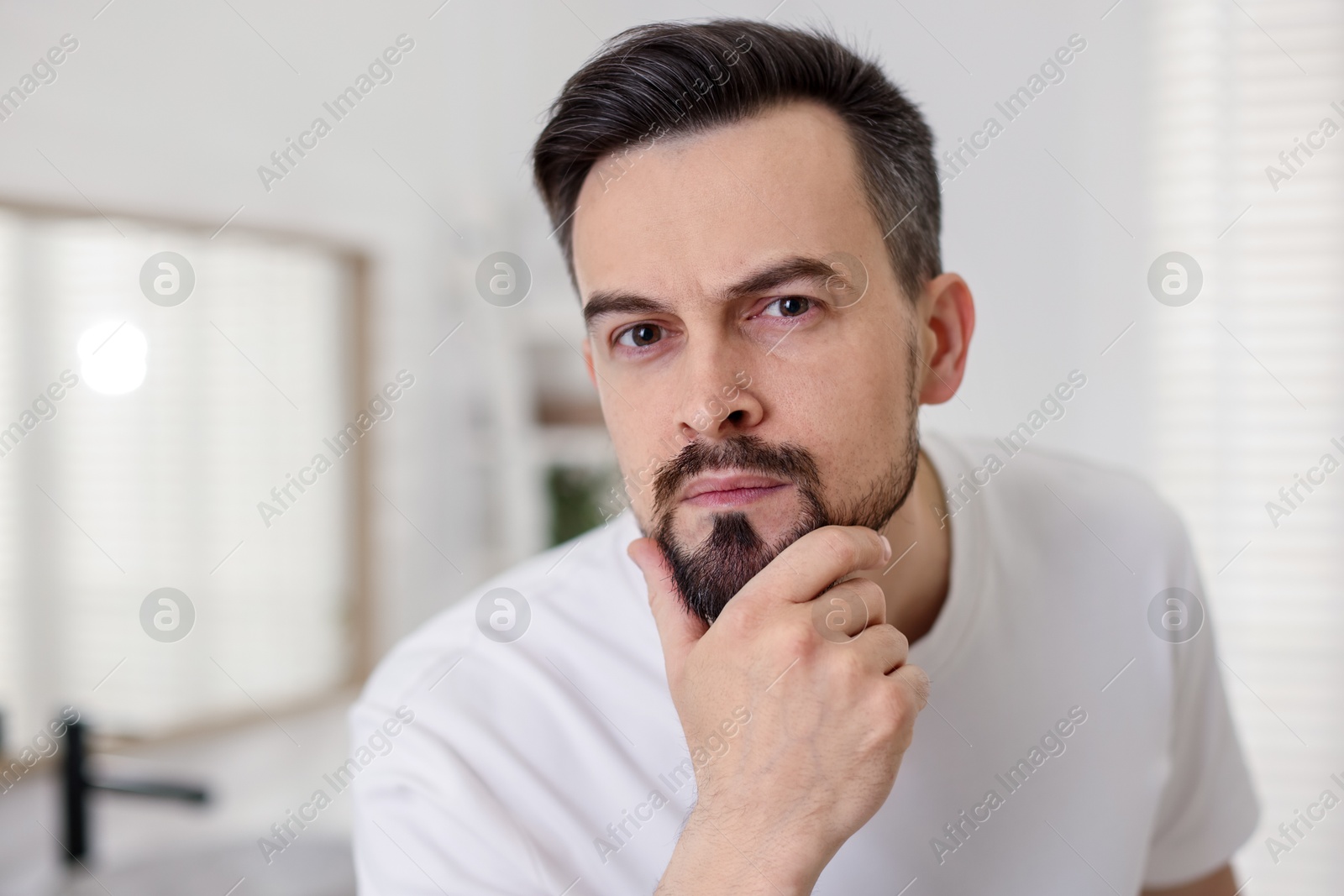 Portrait of handsome man before shaving in bathroom Photo of Portrait of handsome man before shaving in bathroom