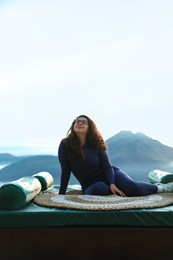 Photo of Beautiful woman enjoying picturesque view of mountains. Space for text