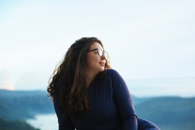 Photo of Beautiful woman enjoying picturesque view of mountains