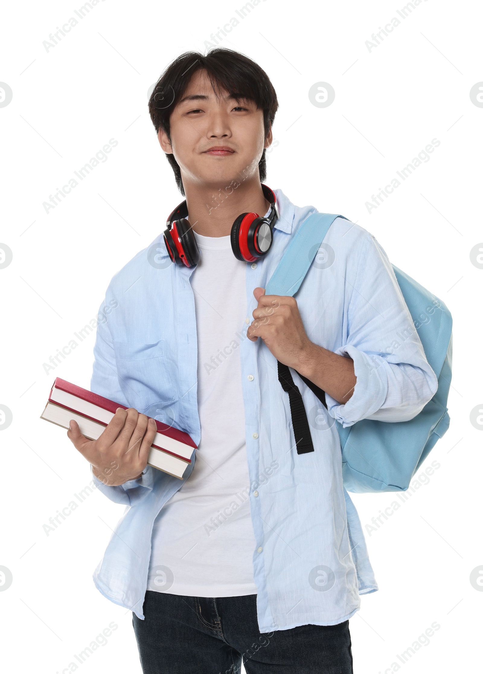 Student with headphones, books and backpack on white background Photo of Student with headphones, books and backpack on white background