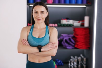 Photo of Beautiful woman wearing sportswear in fitness studio, space for text