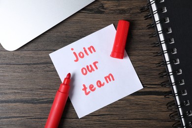 Photo of Paper note with phrase Join Our Team and stationery on wooden table, flat lay