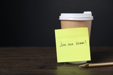 Photo of Paper note with phrase Join Our Team, pen and cup of coffee on wooden table. Space for text