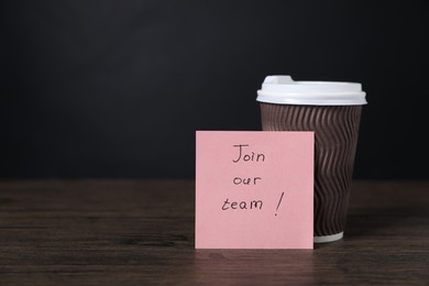 Photo of Paper note with phrase Join Our Team and cup of coffee on wooden table. Space for text