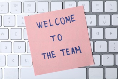 Photo of Paper note with phrase Welcome To The Team on keyboard, top view