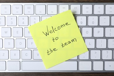 Photo of Paper note with phrase Welcome To The Team on keyboard, top view