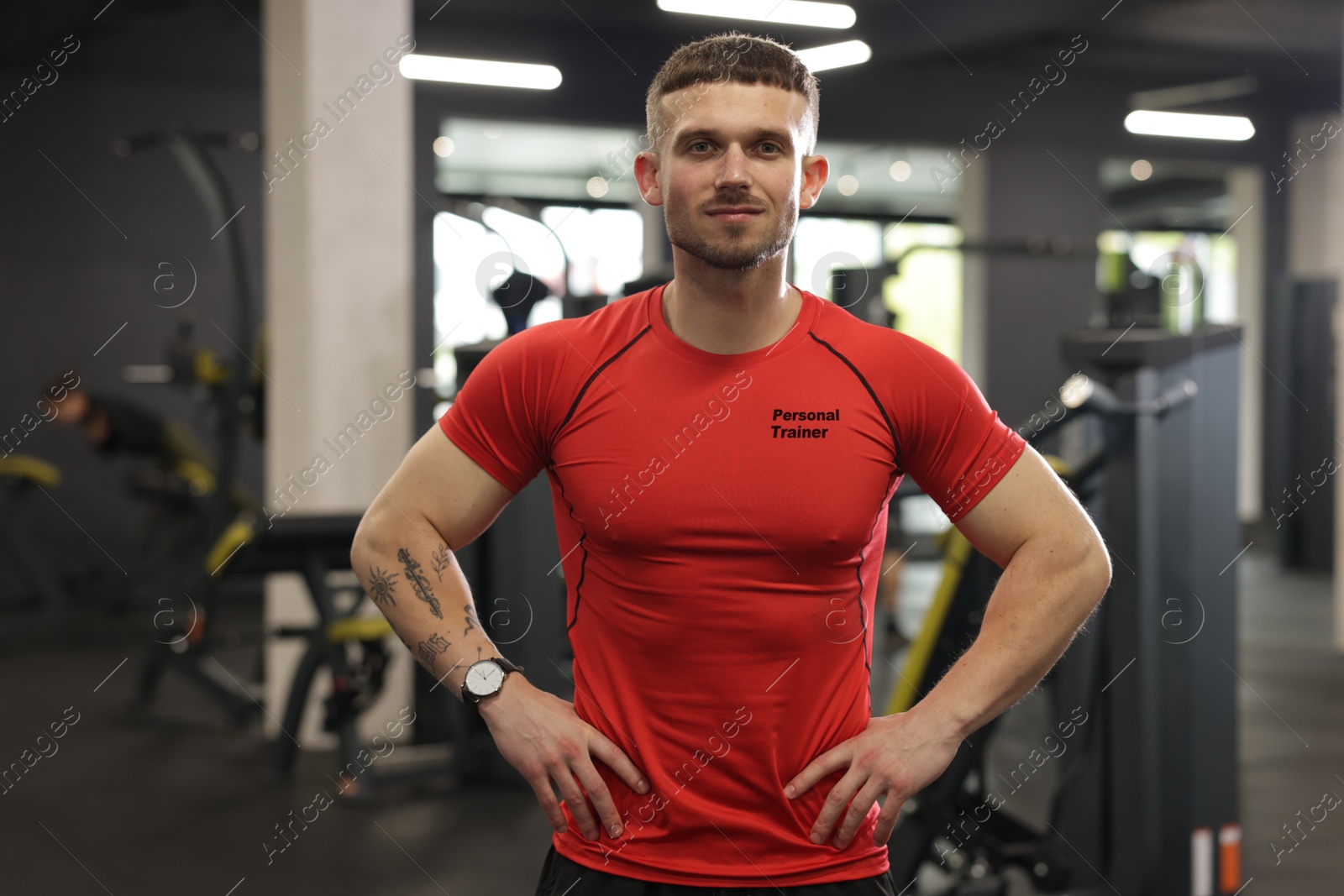 Personal trainer wearing t-shirt with inscription in gym Image of Personal trainer wearing t-shirt with inscription in gym