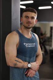 Image of Personal trainer wearing clothing with inscription in gym
