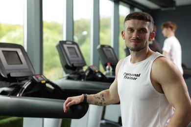 Image of Personal trainer wearing clothing with inscription in gym