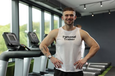 Image of Personal trainer wearing clothing with inscription in gym
