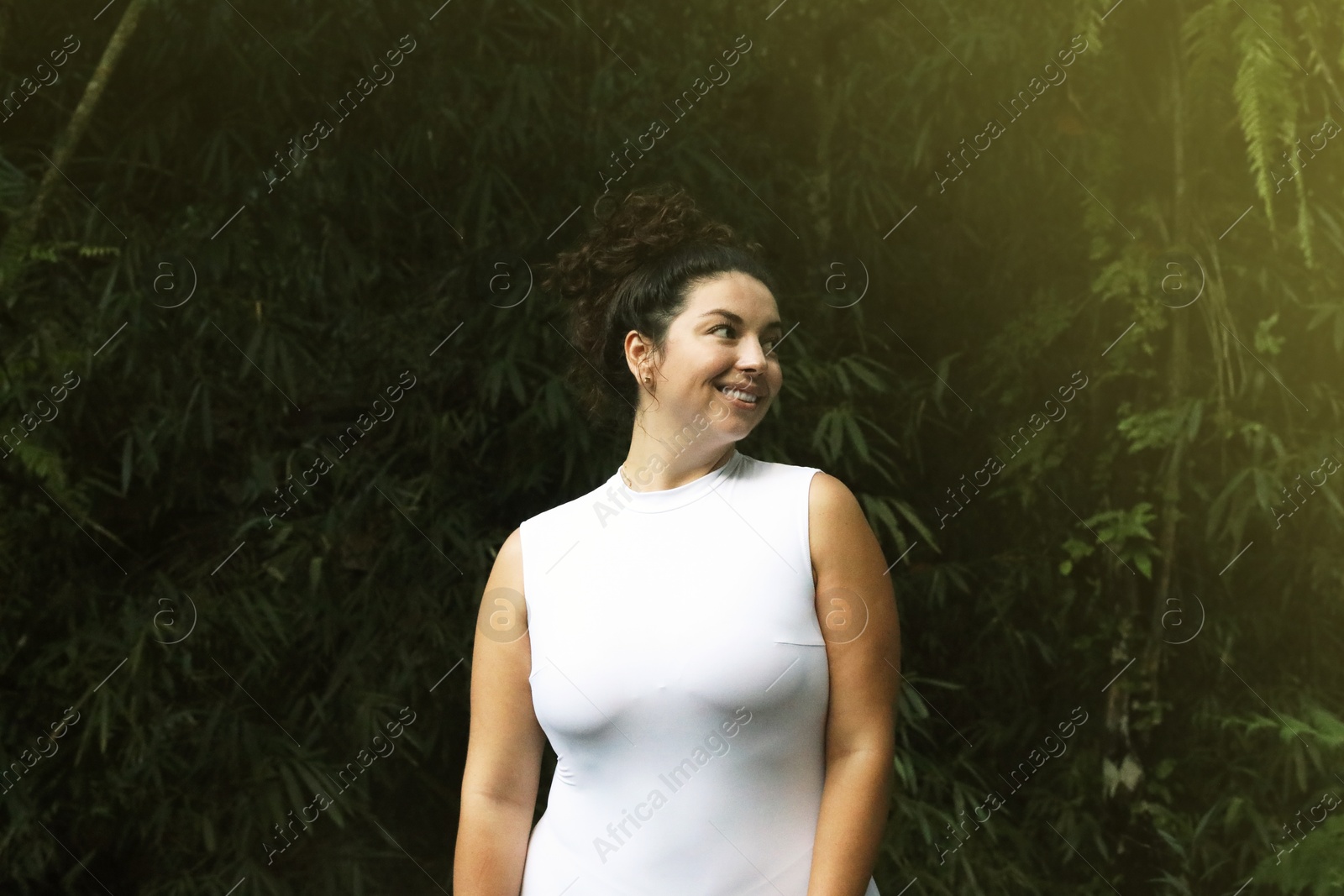 Photo of Portrait of happy woman in tropical forest