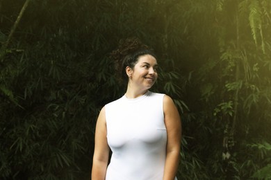 Photo of Portrait of happy woman in tropical forest
