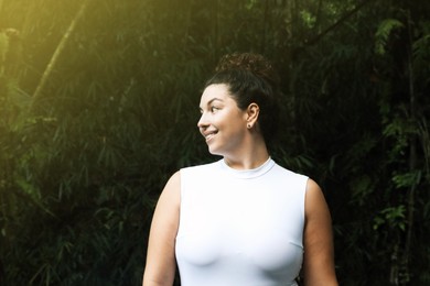 Photo of Portrait of happy woman in tropical forest