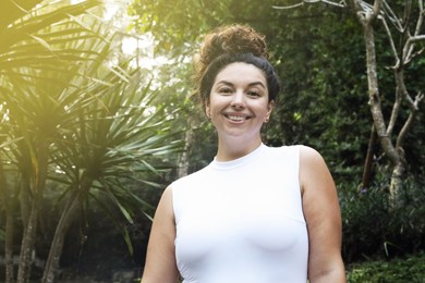 Photo of Portrait of happy woman in tropical forest