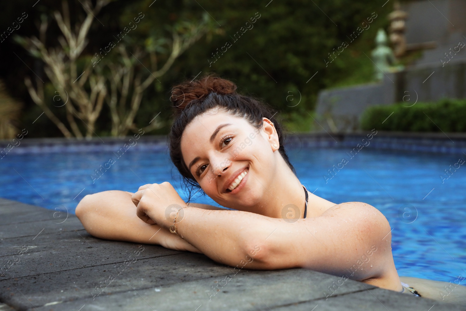 Happy woman relaxing in swimming pool outdoors Photo of Happy woman relaxing in swimming pool outdoors