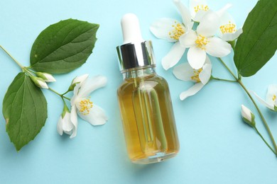 Photo of Essential oil, jasmine flowers and green leaves on light blue background, flat lay