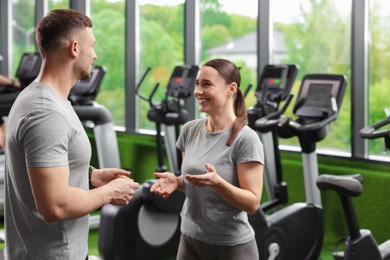 Photo of Professional personal trainers talking in sport center