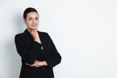Photo of Confident business woman in suit on light background. Space for text