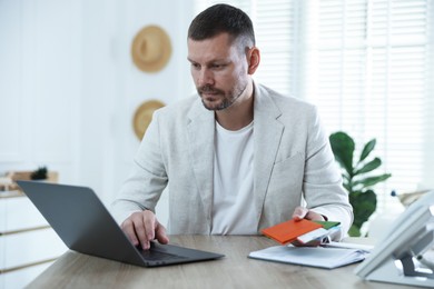 Photo of Travel agent with passports and tickets at wooden table in office