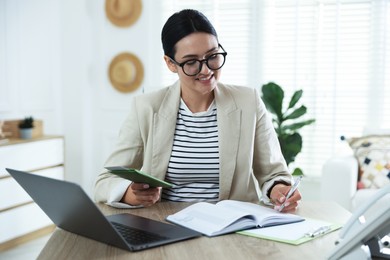 Photo of Travel agent with passport and ticket at wooden table in office