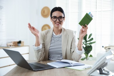Photo of Travel agent with passport and ticket at wooden table in office