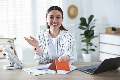 Photo of Travel agent with passports and tickets at wooden table in office
