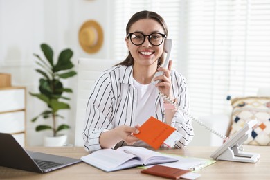 Photo of Travel agent with passport and ticket at wooden table in office