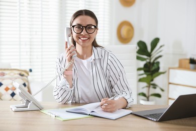 Photo of Travel agent working at wooden table in office
