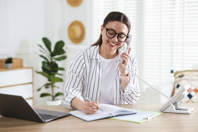 Photo of Travel agent working at wooden table in office