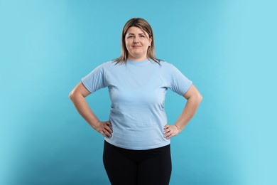 Photo of Weight loss. Plus size woman on light blue background