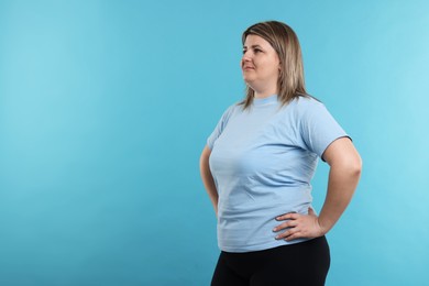 Photo of Weight loss. Plus size woman on light blue background