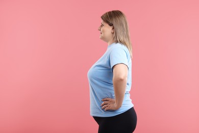 Photo of Weight loss. Plus size woman on pink background
