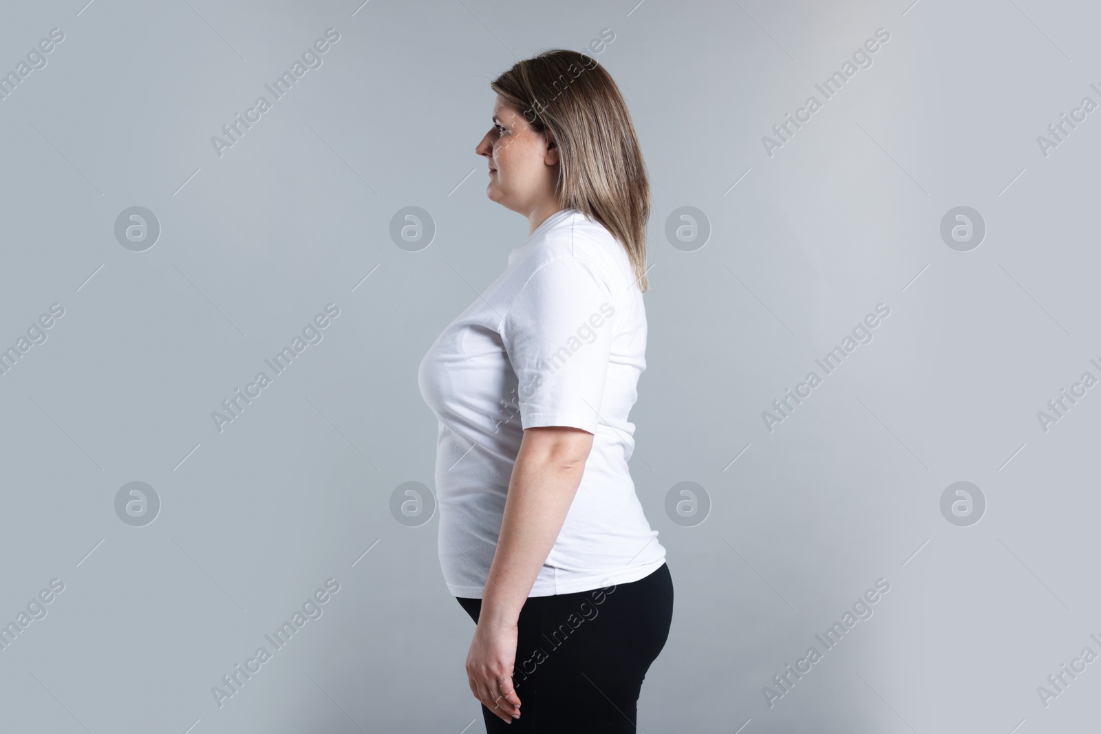 Weight loss. Plus size woman on gray background, space for text Photo of Weight loss. Plus size woman on gray background, space for text