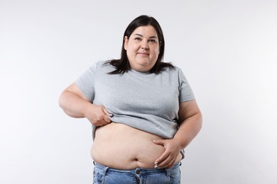 Photo of Woman with excessive belly fat on white background