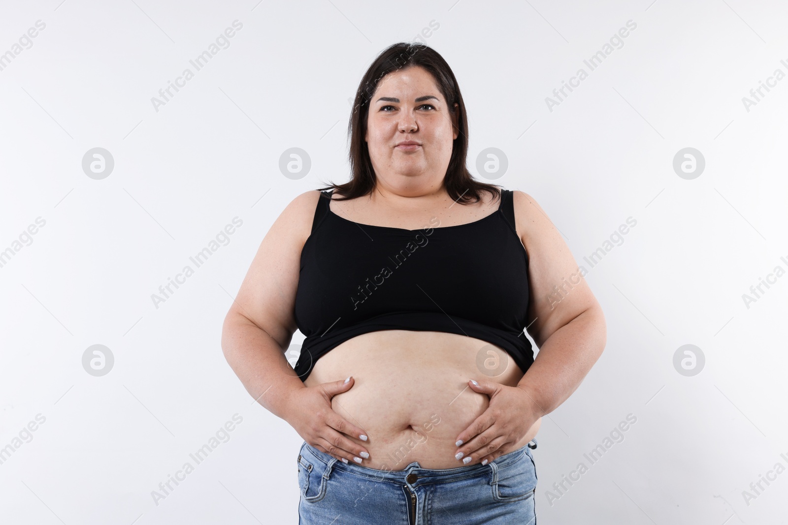 Woman with excessive belly fat on white background Photo of Woman with excessive belly fat on white background