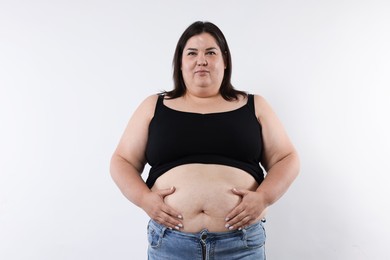 Photo of Woman with excessive belly fat on white background