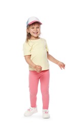 Photo of Happy little girl in baseball hat dancing on white background
