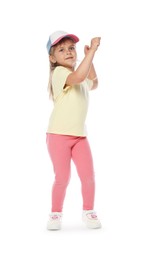 Photo of Happy little girl in baseball hat dancing on white background