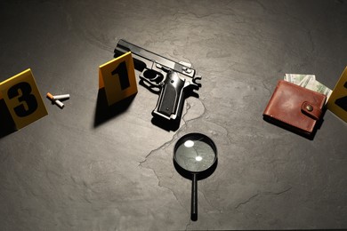 Photo of Forensic expertise. Crime scene with evidence, markers and police tape on grey background, flat lay