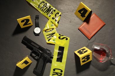 Photo of Forensic expertise. Crime scene with evidence, markers and police tape on grey background, flat lay