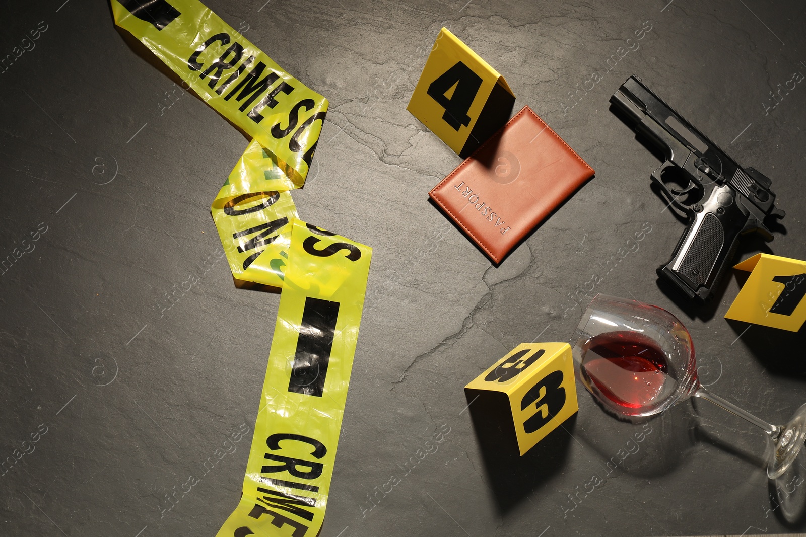 Forensic expertise. Crime scene with evidence, markers and police tape on grey background, flat lay Photo of Forensic expertise. Crime scene with evidence, markers and police tape on grey background, flat lay