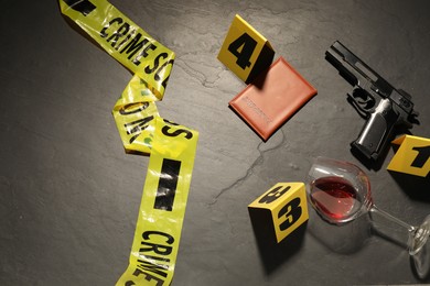 Photo of Forensic expertise. Crime scene with evidence, markers and police tape on grey background, flat lay