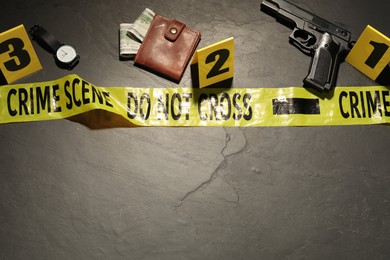Photo of Forensic expertise. Crime scene with evidence, markers and police tape on grey background, flat lay. Space for text